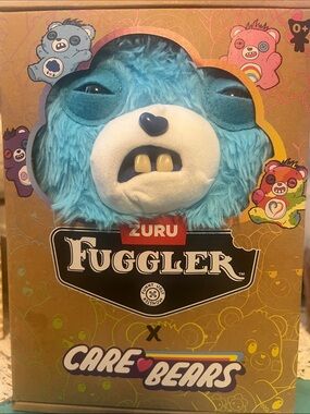 ZURU Fuggler Original 9” size 
Care Bears Blue Plush Grumpy- “I need a hug”